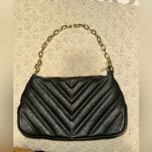 Black leather bag with gold chain